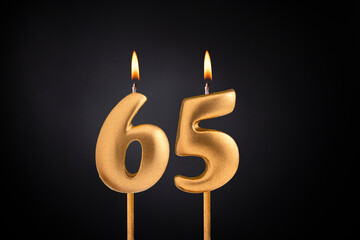 Birthday candle number 65 - Birthday celebration on black background