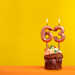 Number 63 birthday candle - Celebration on yellow background