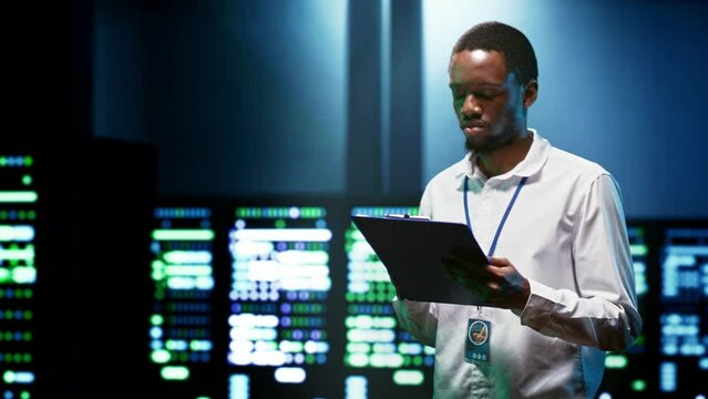 African american engineer preventing supercomputer cybersecurity issues arising due to unsecured network connections. Specialist making sure data center is invulnerable to phishing attacks