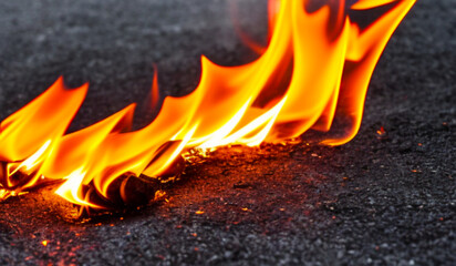 Fire lights on a black background. Fireballs in the night. A burning fire or fire. Danger from fire. The work of a fakir.