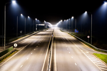 Fototapeta na wymiar Highway during haze at night streetlights lit aerial