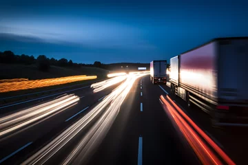 Foto op Plexiglas background photograph of a highway truck on a motorway motion blur light trails evening or night shot of trucks doing logistics and transportation on a highway  © VIX