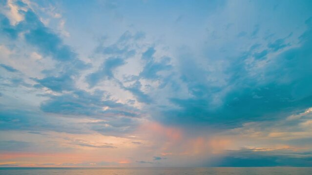 Timelapse: amazing sunset over the Black Sea surface in the evening. Dramatic moving clouds in the sky - getting darker. Cloudscape, seascape, time lapse, summer and nature concept