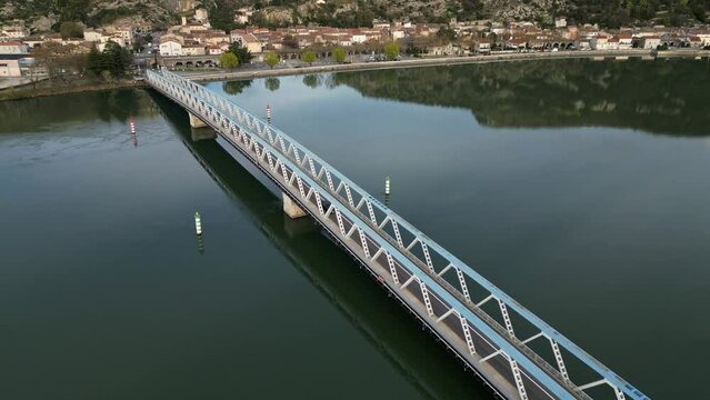 Panoramic view of a metal bridge over the Rhone river at sunrise in the south of France in the village of Le Pouzin (Ardeche)