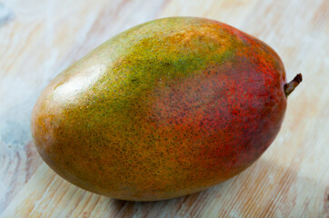 Healthy food, ripe mango on light vintage wooden table