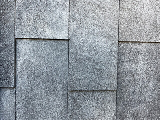 Naklejka premium Texture of laying stones on the ground. Black stone, black with brown stone, cobblestone, construction, stone shadow, dotted rectangular tile for your background