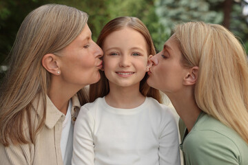Fototapeta premium Three generations. Happy grandmother, her daughter and granddaughter outdoors