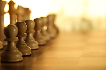 Wooden chess pieces on checkerboard before game, selective focus. Space for text