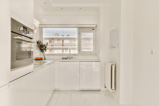 a modern kitchen with white cabinets and appliances on the countertops in an apartment near barcelona, spain - stock photo