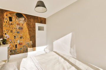 a woman's face painted on the wall next to a bed in a bedroom with white sheets and pillows
