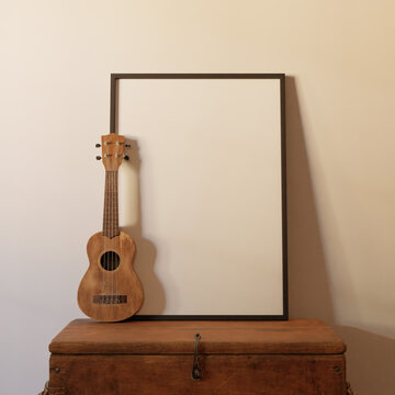 clean minimalist frame mockup poster above the table with ukulele decoration