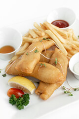 british traditional fish and chips meal in restaurant on white plate - 629752166