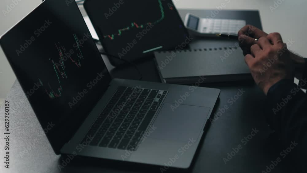 Aufkleber Back view of stock market broker in analyzing data and graphs on multiple computer screens while sitting in modern office.