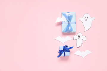 Composition with beautiful gift boxes, ghosts and bats made of paper for Halloween on pink background