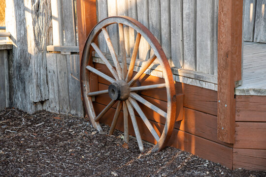 Old wooden wheel in front of a building