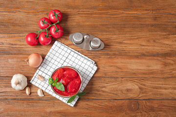 Composition with spices, canned and fresh tomatoes on wooden background