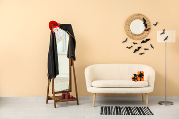 Interior of modern living room decorated for Halloween with sofa, lamp and mirrors