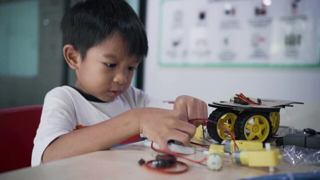 Young asia student learn online at home in coding robot arduino remotely, STEAM, mathematics engineering science technology