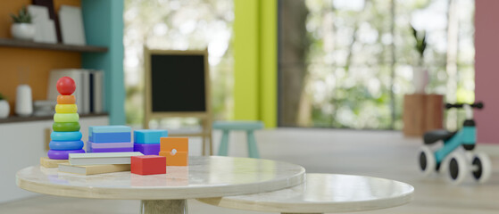 Close-up image of kid toys on a table in a colorful creative kid playroom.