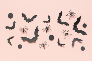 Paper bats and spiders for Halloween party on pink background