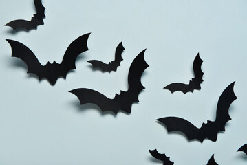 Fototapeta premium Paper bats for Halloween party on blue background