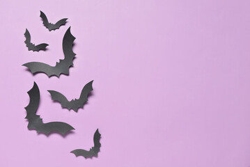 Paper bats for Halloween party on lilac background