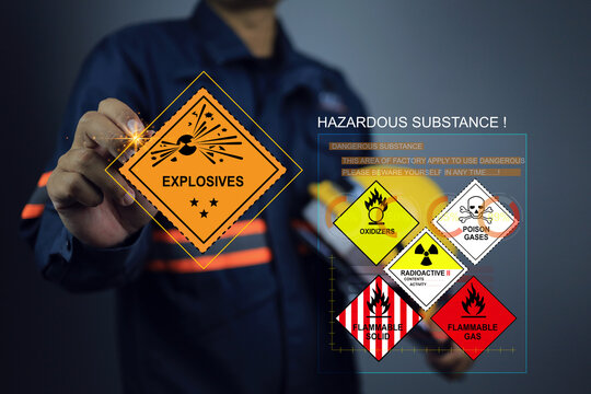 cargo staff or product inspector writing on explosives warning sign and inspect the storage of dangerous goods in the warehouse for operator safety such as explosions, radioactive, toxic gases, etc.