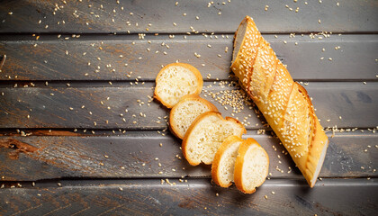 Slices of fresh crispy baguette with sesame. Top view