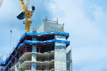 Construction site background. Hoisting cranes and new multi-storey buildings. Industrial...