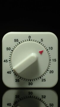 Time lapse of a kitchen clock timer countdown to zero.