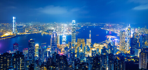Fototapeta na wymiar Hong Kong cityscape with victoria harbour and large group of tall buildings at night