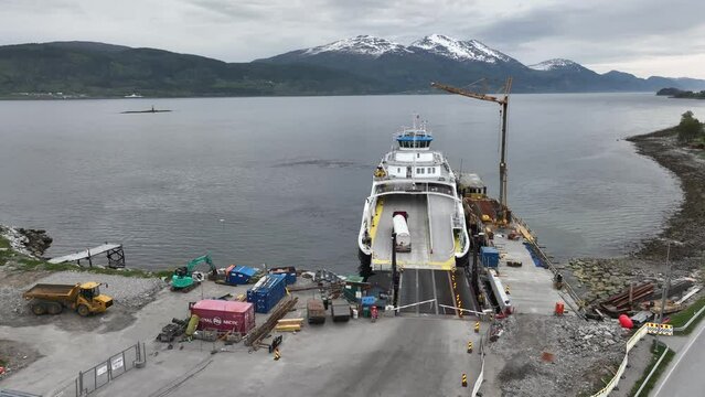 Gate closing and ferry Rodvenfjord preparing for departure Afarnes with dangerous cargo truck loaded on deck