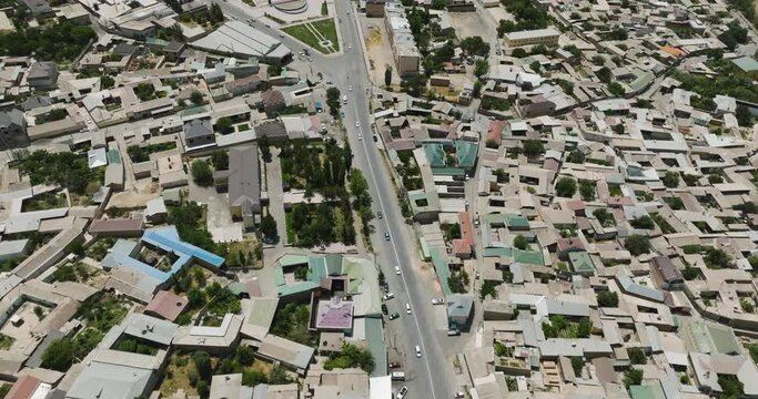 Aerial View Of Istaravshan City With Asphalt Road Between Dense Structures In Sughd Province, Tajikistan. Drone Shot