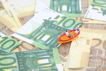 Miniature World Rowing on Paper Currency Background