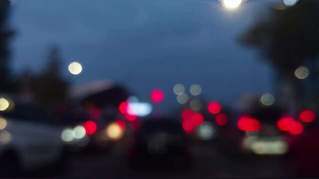 Defocused traffic lights street city abstract . City blur background. Moving bokeh circles of night traffic.