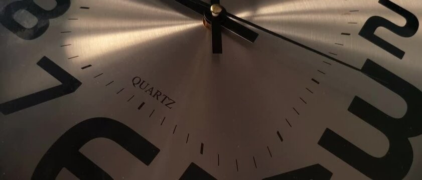 Close up modern wall clock with running time pointer.