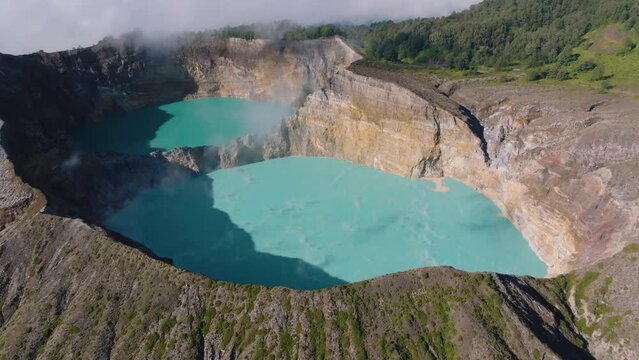 Aerial drone shot of the volcanic crater of the Kelimutu Volcano at Flores Island, Indonesia.