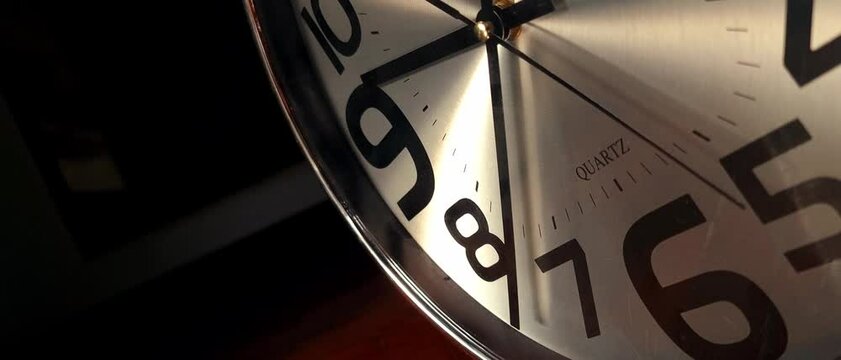 Close up modern wall clock with running time pointer.