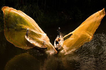 Fototapeta na wymiar Fishing with nets on Nhu Y river, Hue city, Vietnam