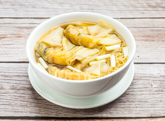 noodles with shrimp dumpling served in dish isolated on wooden table top view hong kong food