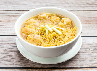 wonton noodles soup served in dish isolated on wooden table top view hong kong food
