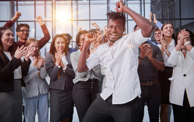 Happy diverse professional business team stand in office looking at camera,