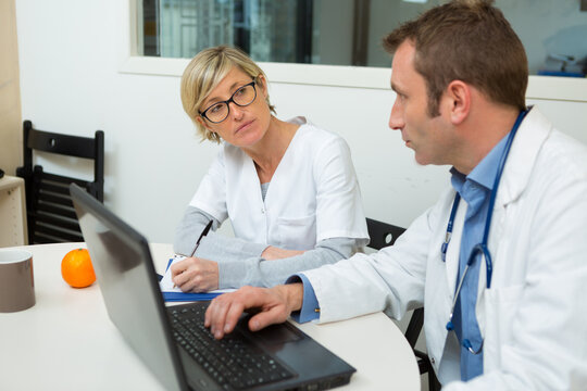 confident doctors discussing in medical office