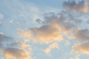 Blue sky background with golden clouds at sunset