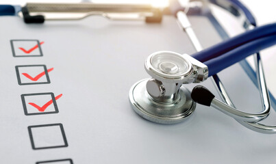 Medical clipboard with checklist and stethoscope