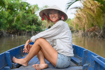 Female tourist on boat in Mekong River Delta, Vietnam