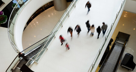 People walking in motion at modern shopping mall