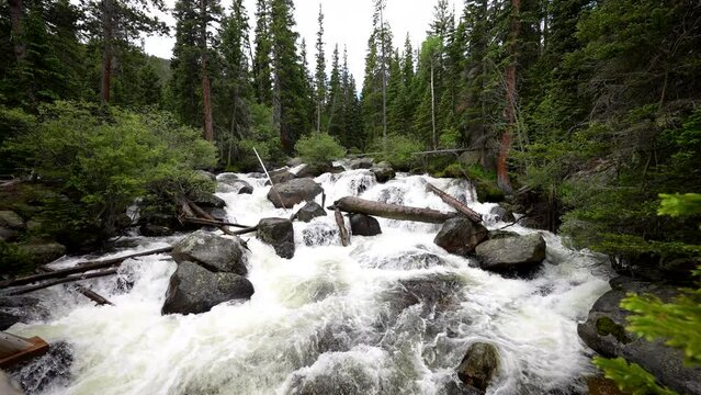 a raging river with sound audio flows down a mountain in the Colorado Rockies