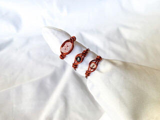 handmade wire ring with beads. wire copper wrapped jewellery, white background.