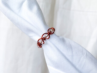 close up of handmade ring. wire copper wrapped jewellery, white background.